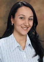Smiling woman with long dark hair wearing a striped shirt, against a brown background—her calm expression contrasts stories of trauma to children often encountered by police.