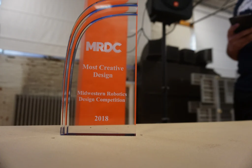 A clear trophy for "Most Creative Design" at the 2018 Midwest Robotics Competition.