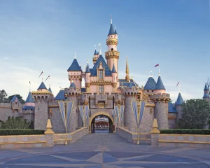 Sleeping Beauty Castle at Disneyland stands under blue skies, its entrance empty—a serene backdrop perfect for envisioning your next Engineering Summit or to reimagine engineering in an inspiring setting.
