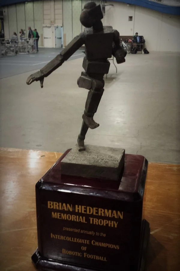 A trophy with a robot figure, labeled "Brian Hederman Memorial Trophy," celebrates Valpo Robotics and honors the champions of robotic football at Valparaiso.