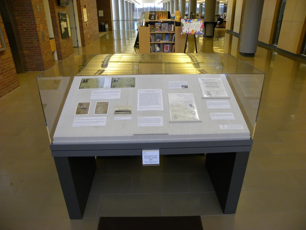 Glass display case with historical documents and photos in a library or museum setting, featuring Holocaust displays at the Christopher Center.