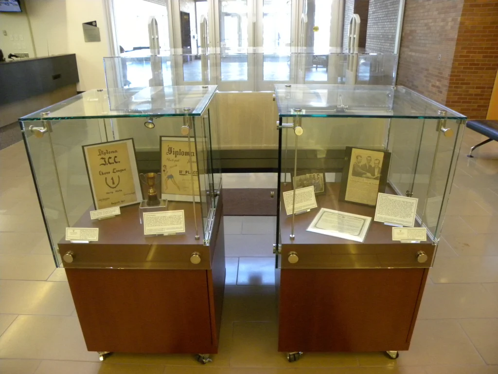 Two glass display cases in the Christopher Center's lobby area hold diplomas, photos, documents, and Holocaust displays.