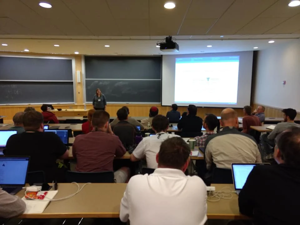 Attendees at Valpo engage in a classroom lecture on Permutation Patterns, with laptops open as they follow the presenter and screen during the International Conference.
