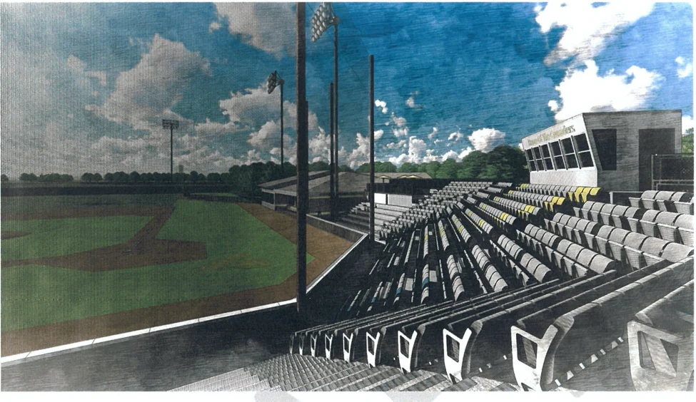 Empty baseball stadium seats face the field under a partly cloudy sky, with lights and a press box visible—showcasing the fresh upgrades from the recent Bauer Field Renovation.