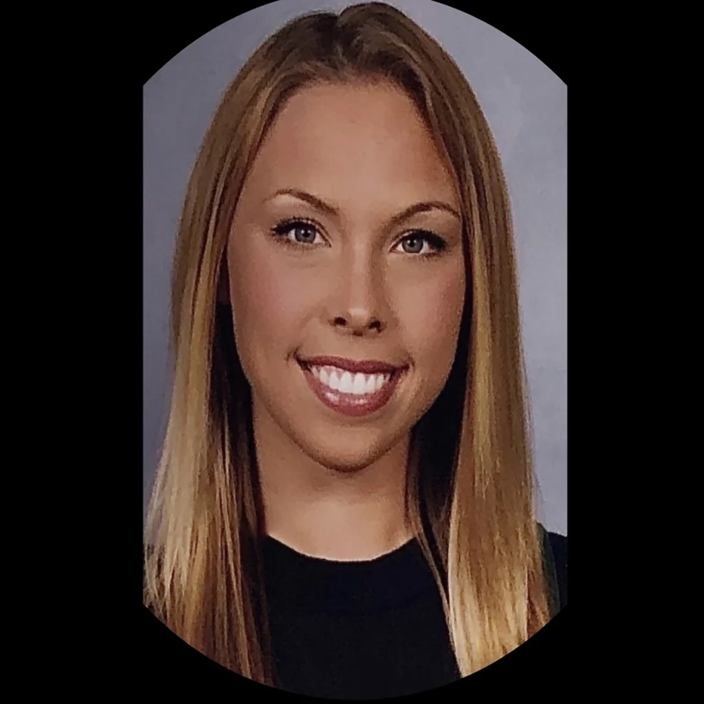 A young woman with long straight blonde hair, one of the Members of the 2020 Class, smiles in a professional headshot against a gray background.