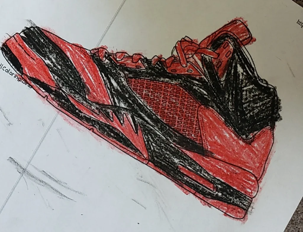 A hand-drawn sneaker colored in red and black on a white sheet of paper, perfect for inspiring ideas about customizing shoes.