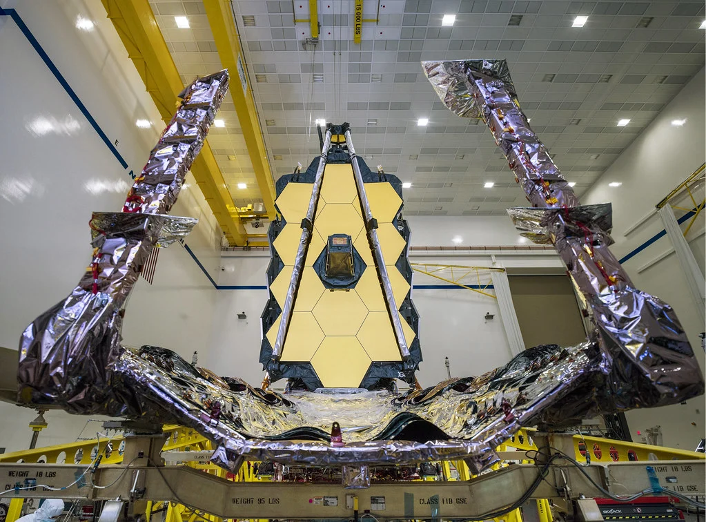 The James Webb Space Telescope, destined to study distant stars, is being assembled in a clean room, with its gold mirrors and sunshield visible. A proud Valparaiso University alumna contributed her expertise to this groundbreaking project.