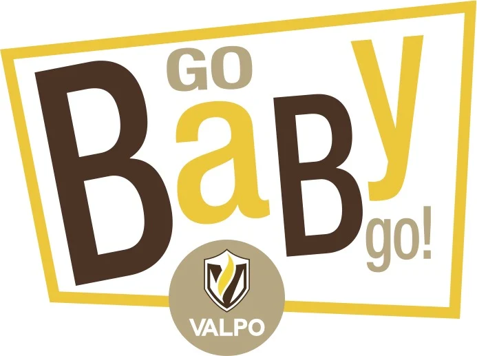 Stylized text reads “GO BaBY go!” above a circular Valpo logo with brown and gold colors, capturing the launching spirit of the GoBabyGo initiative.