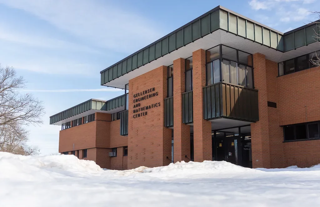 Brick building labeled “Gellersen Engineering and Mathematics Center” with snow covering the ground outside, home to advanced studies like the Masters in Information Technology.