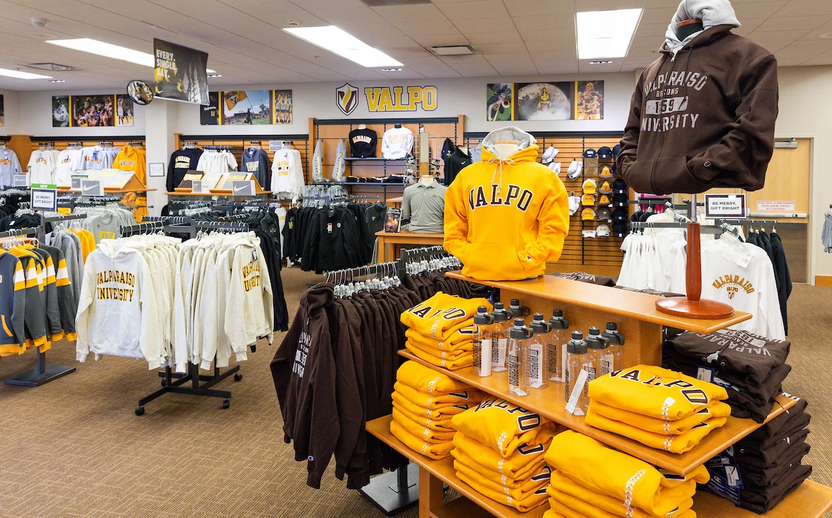 Valparaiso University bookstore welcomes Admitted Students with yellow and brown sweatshirts, shirts, and logo merchandise on display.