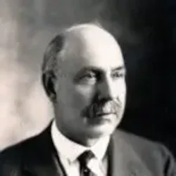 Black and white portrait of a middle-aged man with a mustache, wearing a suit and tie, embodying leadership and governance.