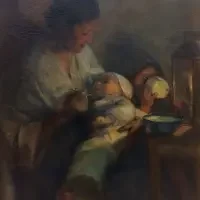 A woman bottle-feeds a baby while sitting beside a small table with a lantern and bowl, capturing intimate moments often showcased in Exhibitions & Series.