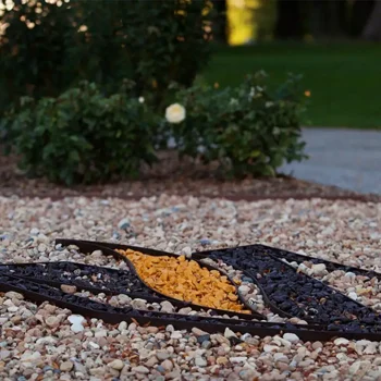 Decorative gravel design with orange and dark stones arranged in a pattern on a rocky garden ground, available through Valpo Digital Downloads.
