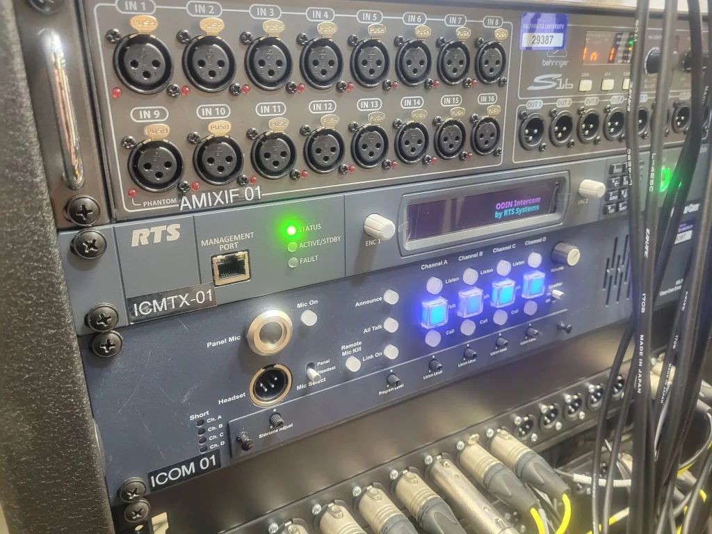 Close-up of audio equipment rack with cables, buttons, and digital display screens in an ESPN Valparaiso University Productions studio setting.