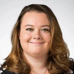 Olivia Gorman, NCC, LMHC, with shoulder-length brown hair, smiles at the camera against a plain light background.