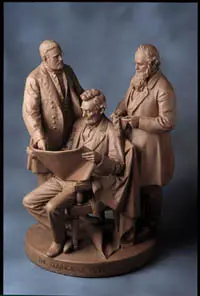 A statue of three men—one seated holding a paper, two standing beside him—all dressed in 19th-century clothing, reflecting themes of American Art and National Identity.
