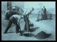 Two men shovel gravel while others work in the background at an outdoor site, reflecting themes of American Art and National Identity through their collective labor.