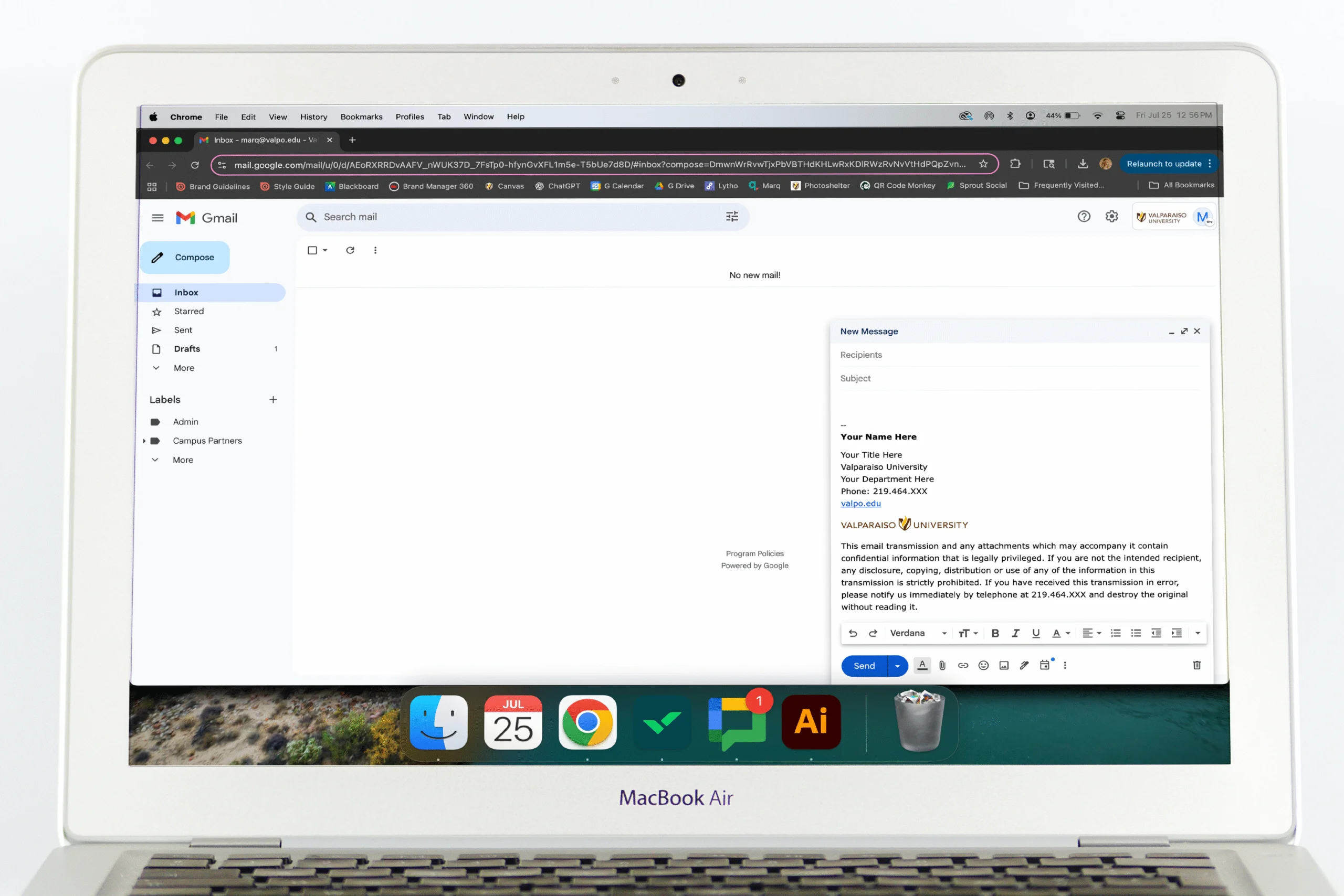 A MacBook Air displaying a Gmail draft email with an elegant email signature on its screen.