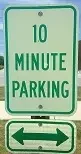 Green and white parking sign reads "10 minute parking" with a double arrow pointing left and right below.