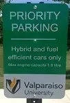 Green parking sign reads: "PRIORITY PARKING Hybrid and fuel efficient cars only. Valparaiso University.