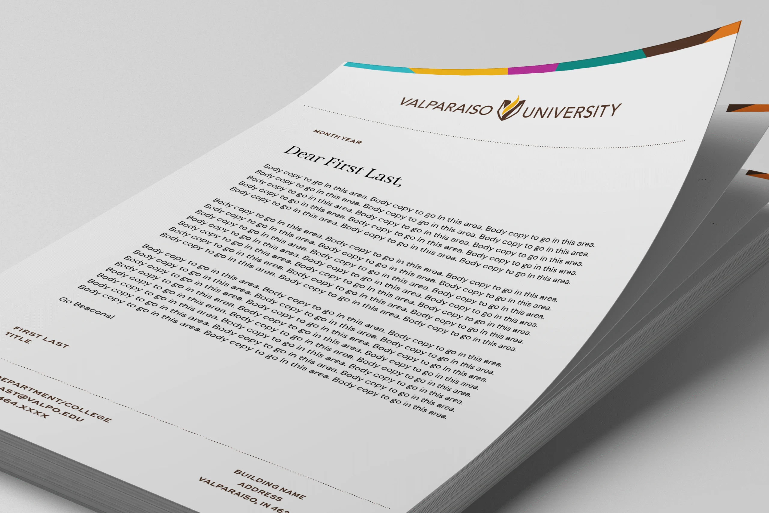 A stack of Valparaiso University letterheads, featuring a mock letter addressed to "First Last.